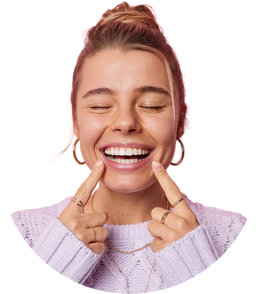 READY - young adult woman with eyes closed pointing at perfect teeth
